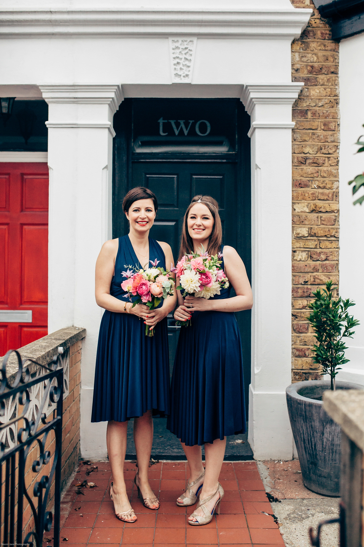 Bride Dany wears a 1950's inspired lace dress and birdcage veil for her modern cool wedding at The Asylum. Their reception was held in a London pub. Photography by Naomi Jane.