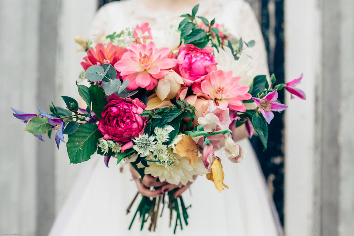 Bride Dany wears a 1950's inspired lace dress and birdcage veil for her modern cool wedding at The Asylum. Their reception was held in a London pub. Photography by Naomi Jane.