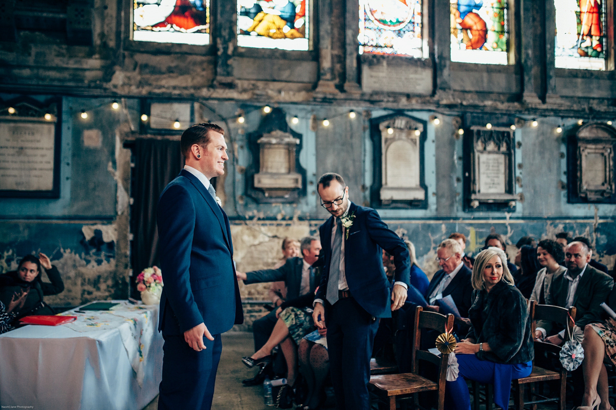 Bride Dany wears a 1950's inspired lace dress and birdcage veil for her modern cool wedding at The Asylum. Their reception was held in a London pub. Photography by Naomi Jane.