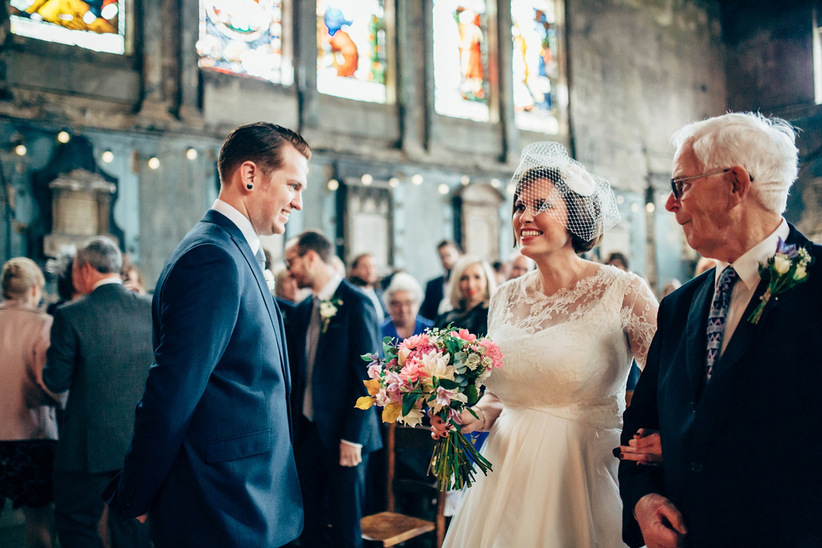 Bride Dany wears a 1950's inspired lace dress and birdcage veil for her modern cool wedding at The Asylum. Their reception was held in a London pub. Photography by Naomi Jane.