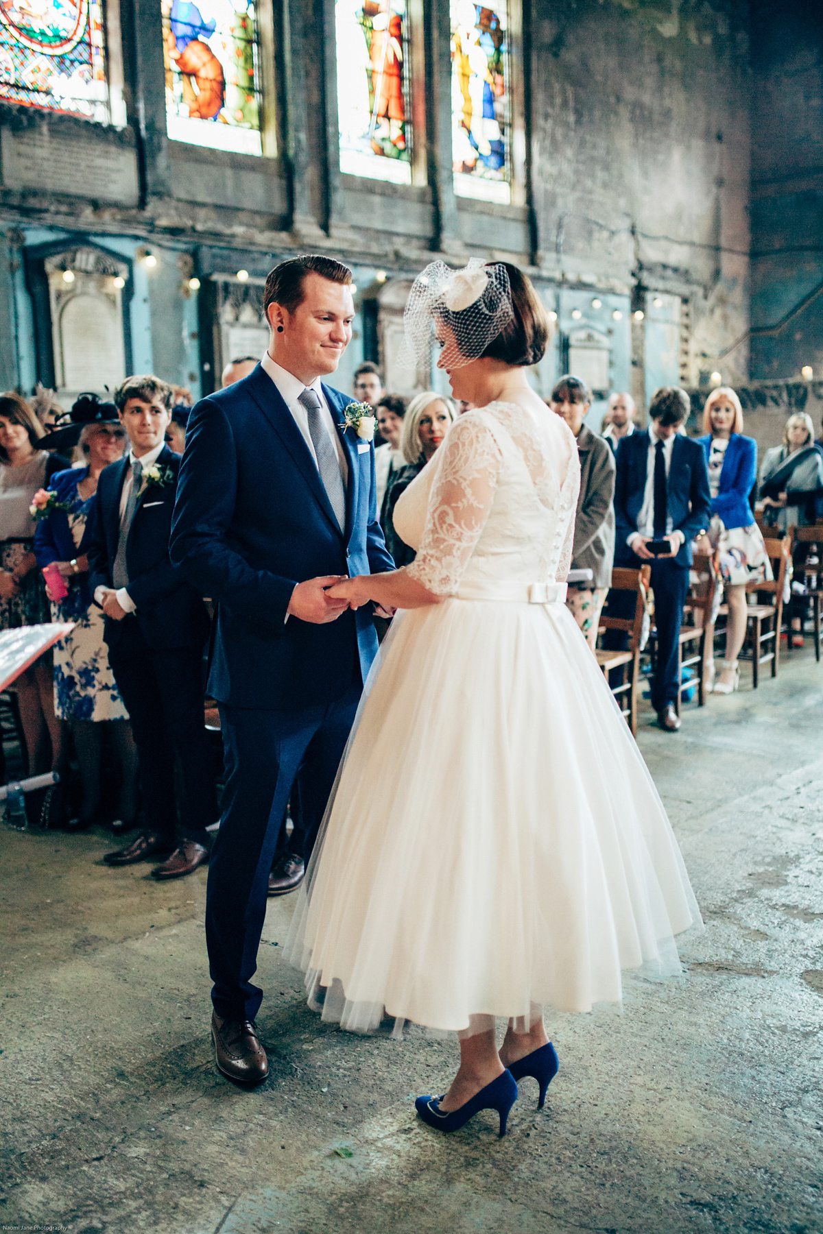 Bride Dany wears a 1950's inspired lace dress and birdcage veil for her modern cool wedding at The Asylum. Their reception was held in a London pub. Photography by Naomi Jane.