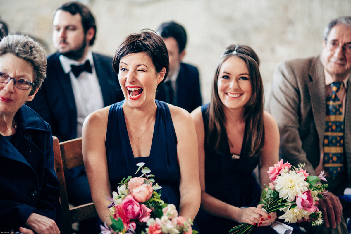 Bride Dany wears a 1950's inspired lace dress and birdcage veil for her modern cool wedding at The Asylum. Their reception was held in a London pub. Photography by Naomi Jane.