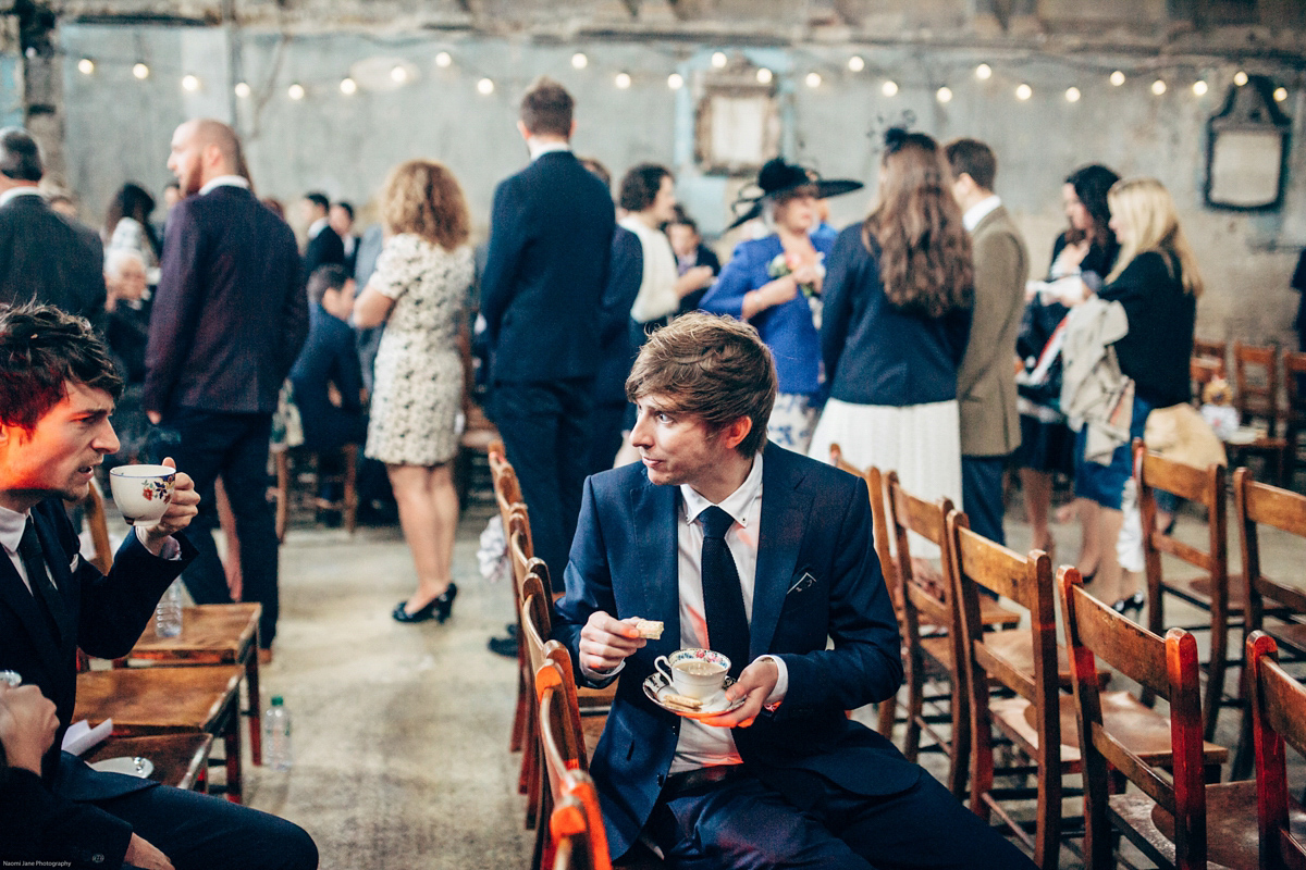 Bride Dany wears a 1950's inspired lace dress and birdcage veil for her modern cool wedding at The Asylum. Their reception was held in a London pub. Photography by Naomi Jane.