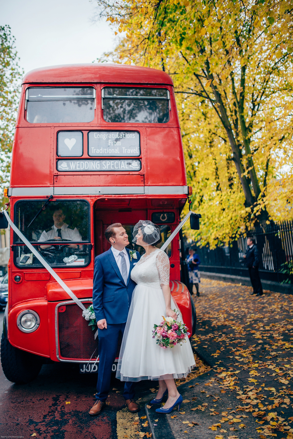 Bride Dany wears a 1950's inspired lace dress and birdcage veil for her modern cool wedding at The Asylum. Their reception was held in a London pub. Photography by Naomi Jane.