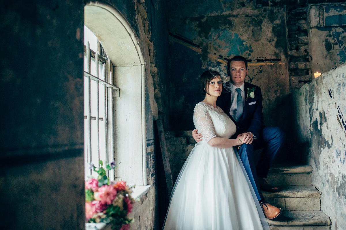 Bride Dany wears a 1950's inspired lace dress and birdcage veil for her modern cool wedding at The Asylum. Their reception was held in a London pub. Photography by Naomi Jane.