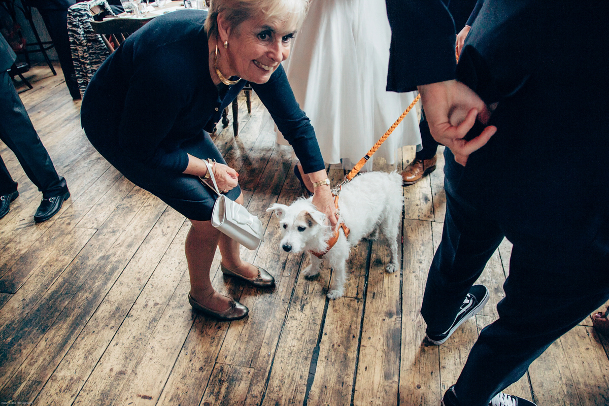 Bride Dany wears a 1950's inspired lace dress and birdcage veil for her modern cool wedding at The Asylum. Their reception was held in a London pub. Photography by Naomi Jane.