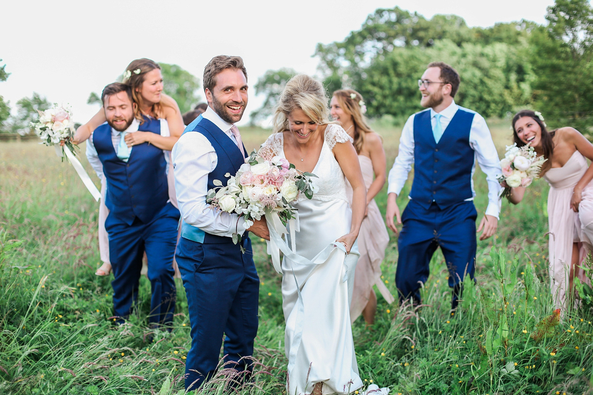 Sophie wore a Sassi Holford gown for her romantic English country garden wedding in pastel shades. Captured by Amy Fanton Photography.