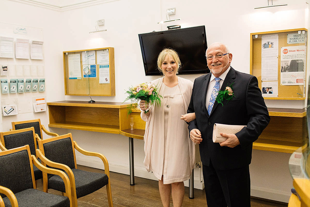 Celine wore a short, chic, pale pink wedding dress for her non-traditional wedding at the Greenwich Yacht Club in London. Captured by Paul Joseph Photography.