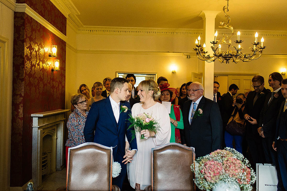 Celine wore a short, chic, pale pink wedding dress for her non-traditional wedding at the Greenwich Yacht Club in London. Captured by Paul Joseph Photography.