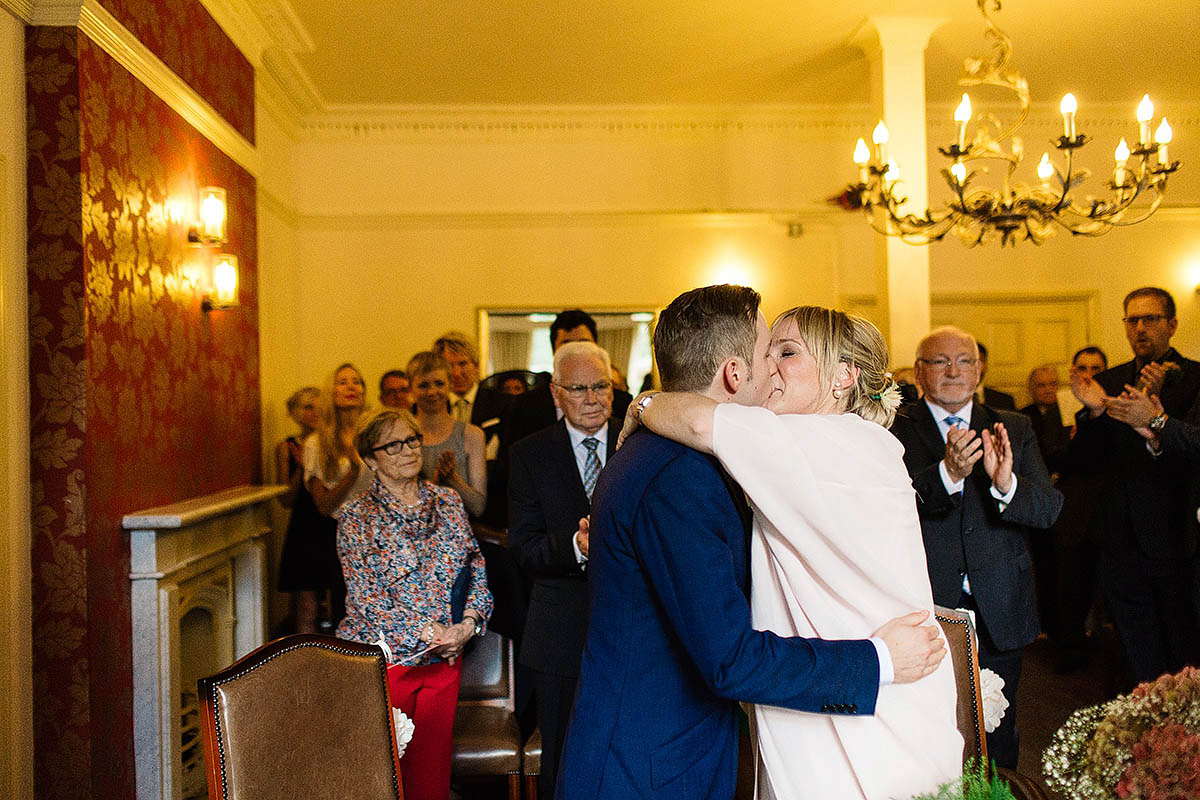 Celine wore a short, chic, pale pink wedding dress for her non-traditional wedding at the Greenwich Yacht Club in London. Captured by Paul Joseph Photography.