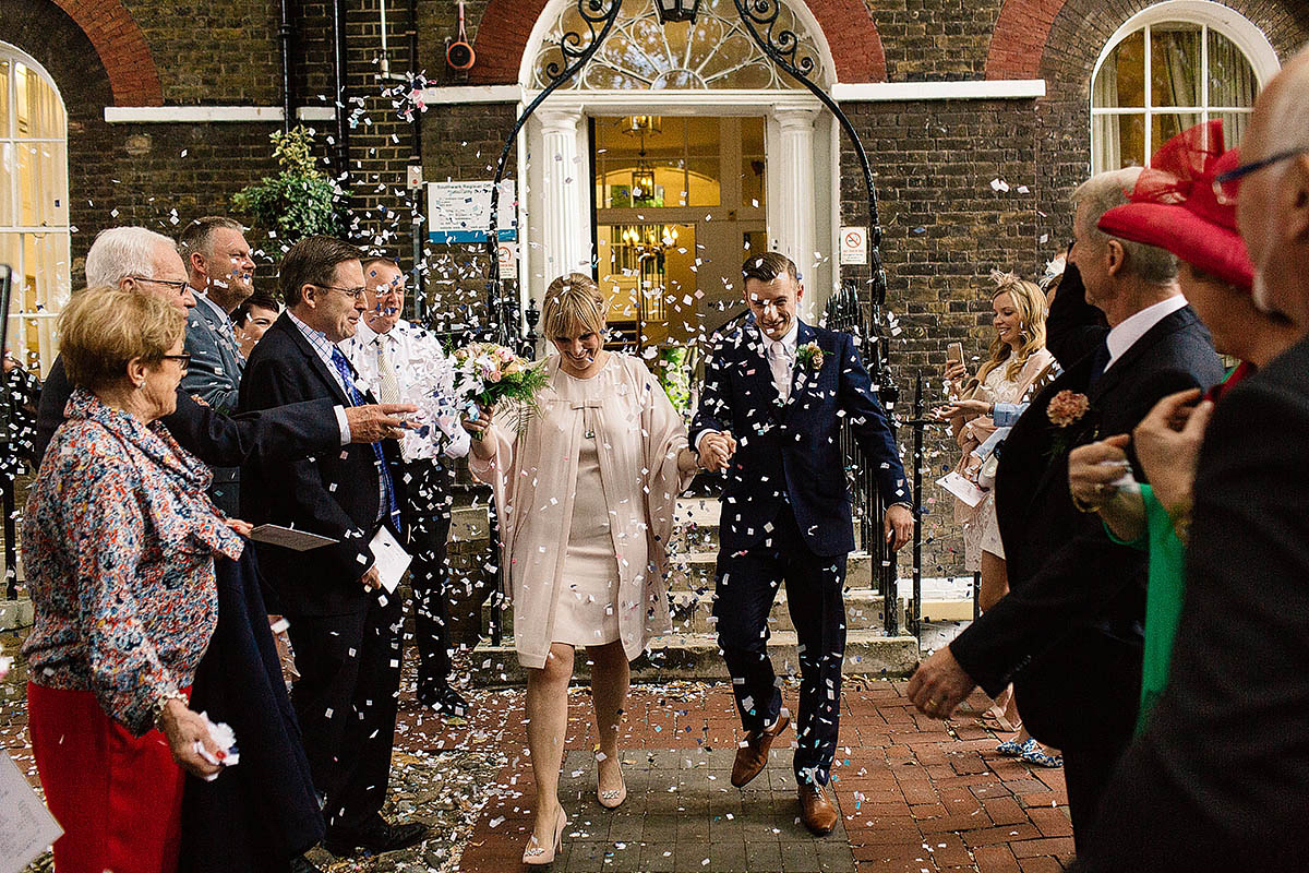 Celine wore a short, chic, pale pink wedding dress for her non-traditional wedding at the Greenwich Yacht Club in London. Captured by Paul Joseph Photography.