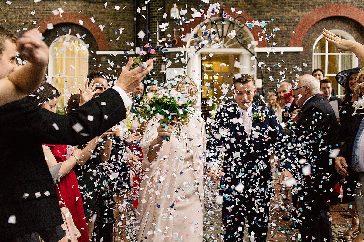 Celine wore a short, chic, pale pink wedding dress for her non-traditional wedding at the Greenwich Yacht Club in London. Captured by Paul Joseph Photography.