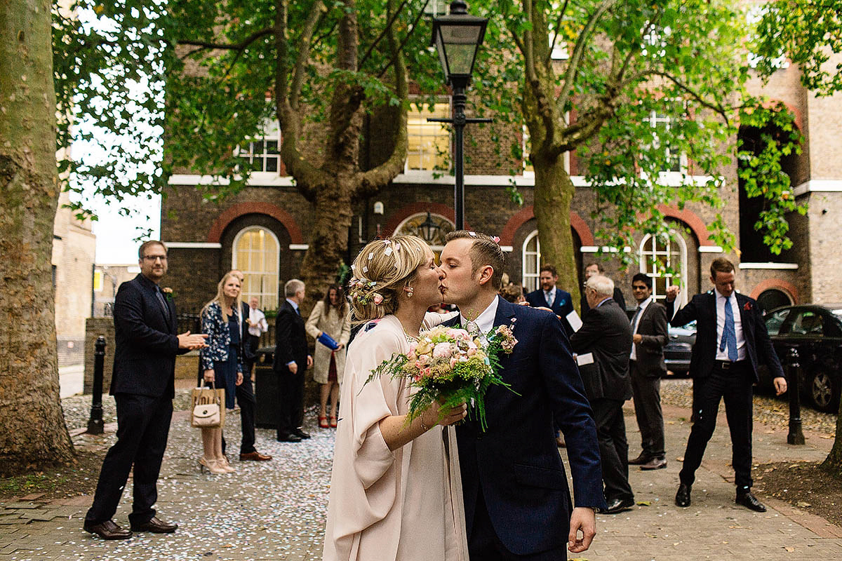 Celine wore a short, chic, pale pink wedding dress for her non-traditional wedding at the Greenwich Yacht Club in London. Captured by Paul Joseph Photography.