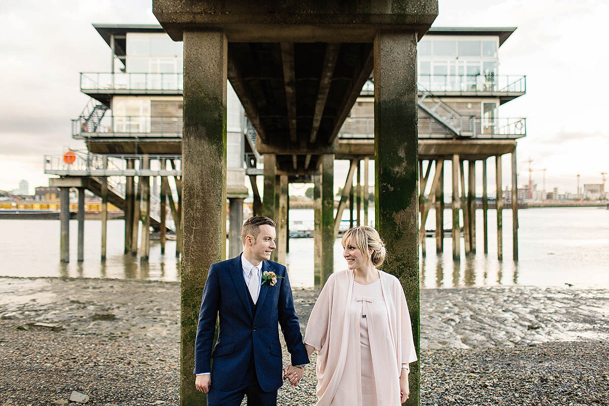 Celine wore a short, chic, pale pink wedding dress for her non-traditional wedding at the Greenwich Yacht Club in London. Captured by Paul Joseph Photography.