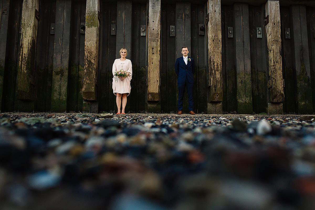 Celine wore a short, chic, pale pink wedding dress for her non-traditional wedding at the Greenwich Yacht Club in London. Captured by Paul Joseph Photography.