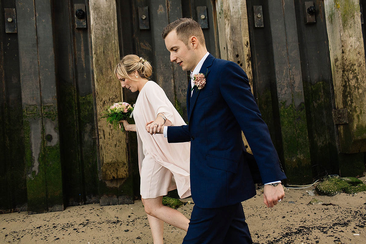 Celine wore a short, chic, pale pink wedding dress for her non-traditional wedding at the Greenwich Yacht Club in London. Captured by Paul Joseph Photography.