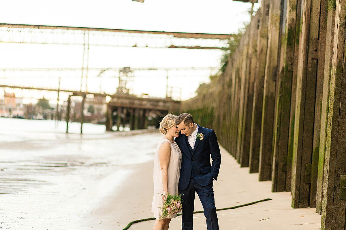 Celine wore a short, chic, pale pink wedding dress for her non-traditional wedding at the Greenwich Yacht Club in London. Captured by Paul Joseph Photography.