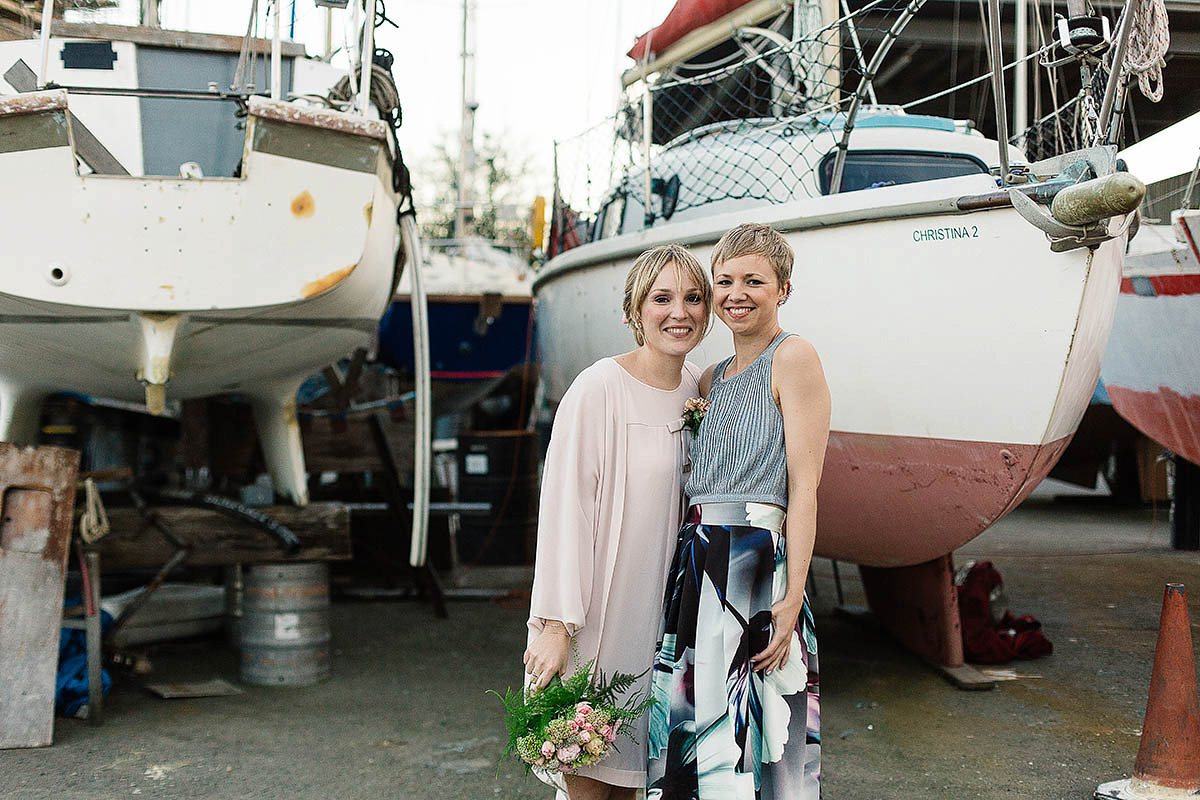 Celine wore a short, chic, pale pink wedding dress for her non-traditional wedding at the Greenwich Yacht Club in London. Captured by Paul Joseph Photography.