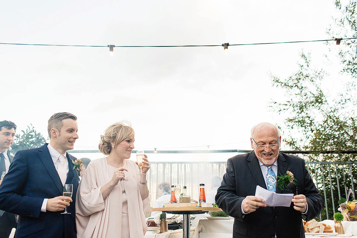 Celine wore a short, chic, pale pink wedding dress for her non-traditional wedding at the Greenwich Yacht Club in London. Captured by Paul Joseph Photography.