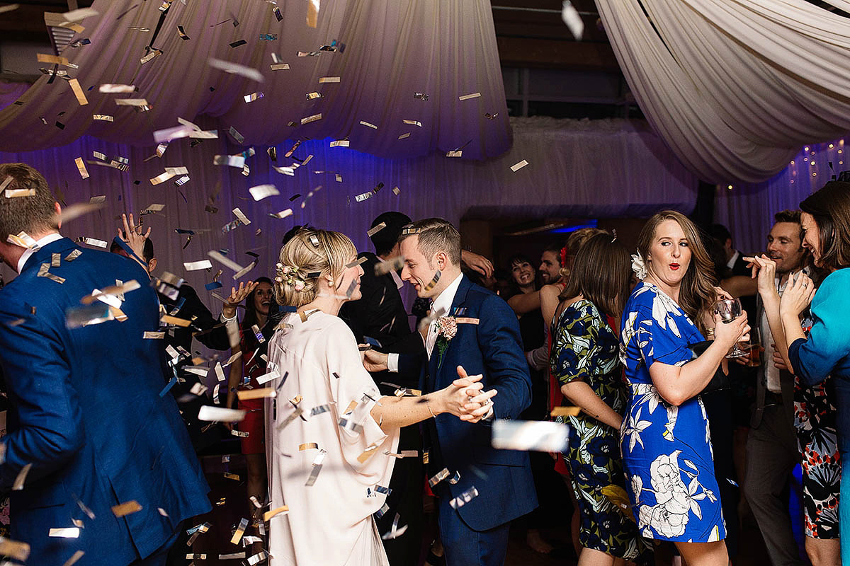 Celine wore a short, chic, pale pink wedding dress for her non-traditional wedding at the Greenwich Yacht Club in London. Captured by Paul Joseph Photography.