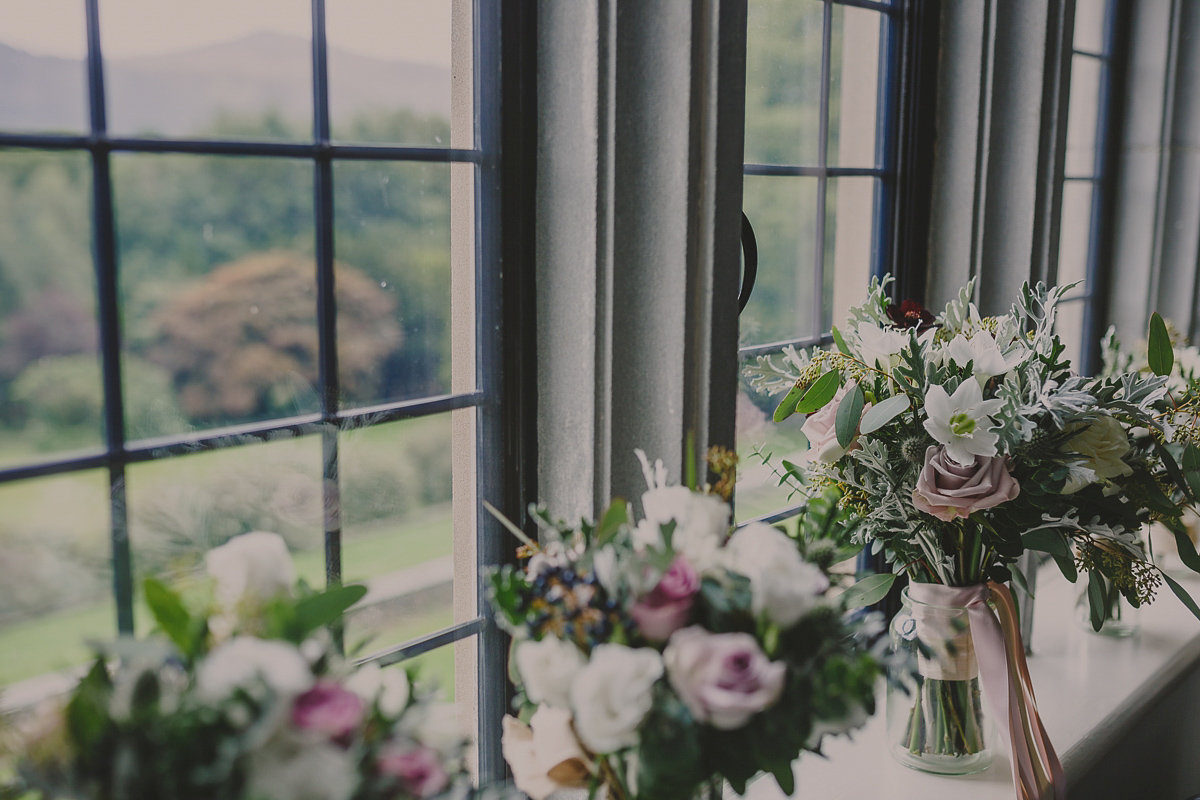 Bride Lucy wore the 'Peony' gown by Naomi Neoh for her romantic and elegant gin inspired wedding in the Lake District. Photography by Lottie Elizabeth.