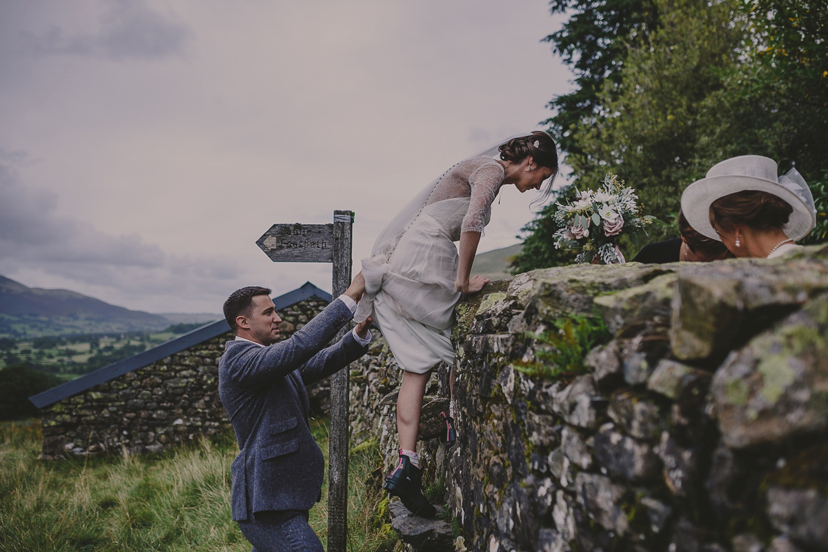 Bride Lucy wore the 'Peony' gown by Naomi Neoh for her romantic and elegant gin inspired wedding in the Lake District. Photography by Lottie Elizabeth.