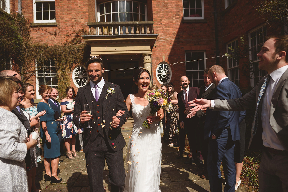 Bride Sarah wore a Lusan Mandongus gown and a dried flower headpiece for her relaxed and elegant wedding at Walcot Hall. Photography by Jackson & Co.