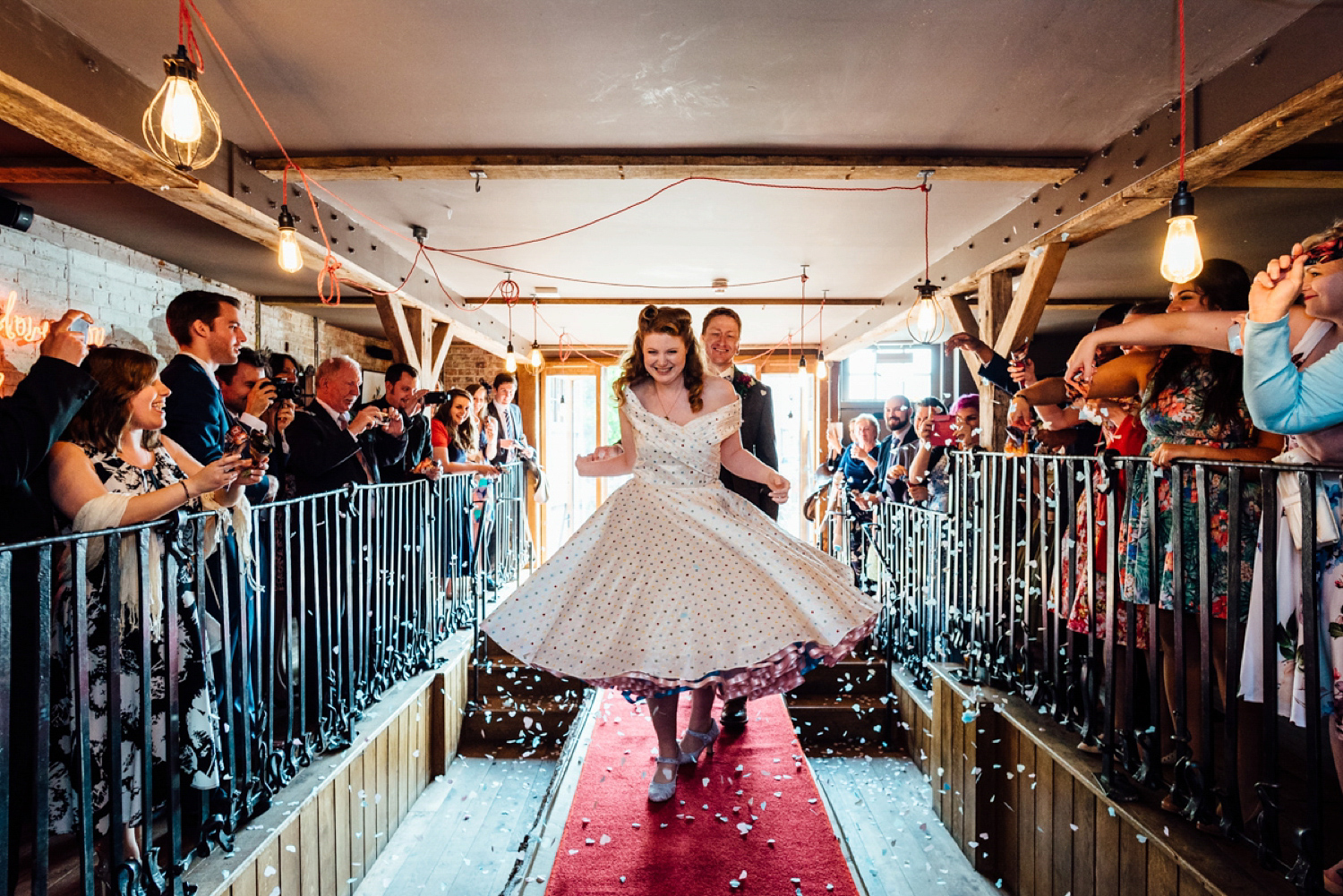 Bride Frankie wore a 1950's inspired, colourful polka dot dress by 'Oh My Honey' for her geek-chic and reto inspired wedding. Photography by Anna Pumer.