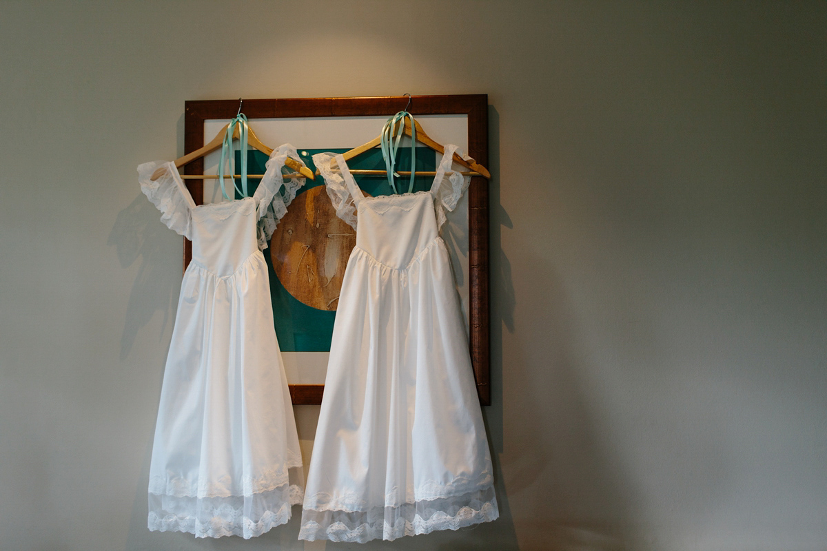 Bride Emma-Jane wore a pale pink skirt and lace top for her Scottish chapel wedding. Her maids wore pale blue and floral crowns. Photography by Caro Weiss.