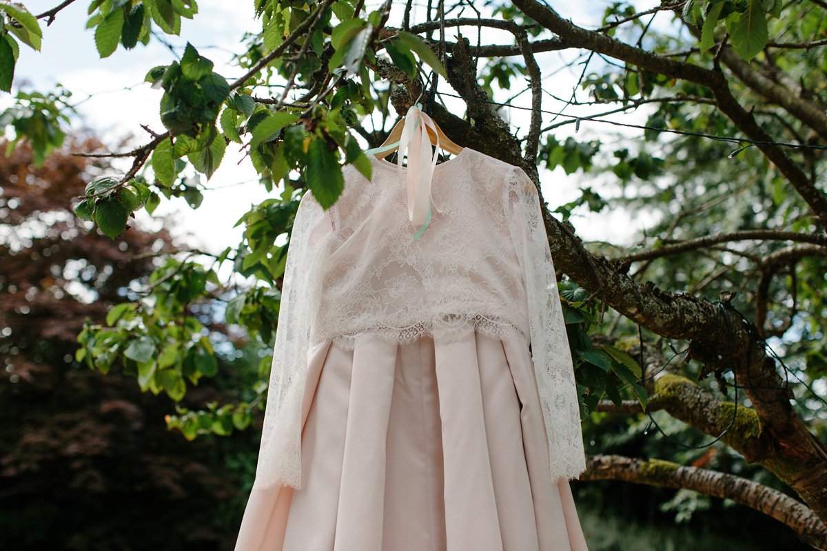 Bride Emma-Jane wore a pale pink skirt and lace top for her Scottish chapel wedding. Her maids wore pale blue and floral crowns. Photography by Caro Weiss.