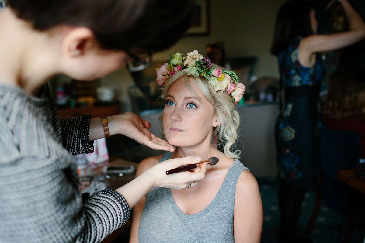 Bride Emma-Jane wore a pale pink skirt and lace top for her Scottish chapel wedding. Her maids wore pale blue and floral crowns. Photography by Caro Weiss.