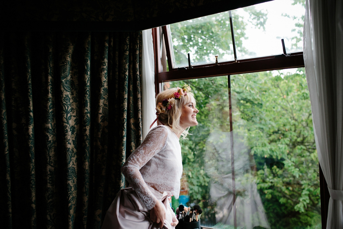 Bride Emma-Jane wore a pale pink skirt and lace top for her Scottish chapel wedding. Her maids wore pale blue and floral crowns. Photography by Caro Weiss.