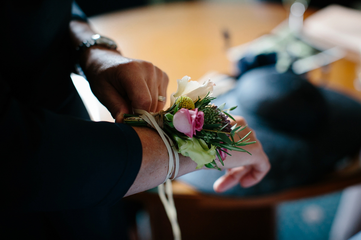 Bride Emma-Jane wore a pale pink skirt and lace top for her Scottish chapel wedding. Her maids wore pale blue and floral crowns. Photography by Caro Weiss.