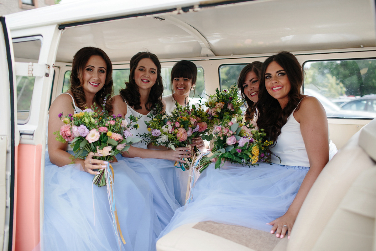 Bride Emma-Jane wore a pale pink skirt and lace top for her Scottish chapel wedding. Her maids wore pale blue and floral crowns. Photography by Caro Weiss.