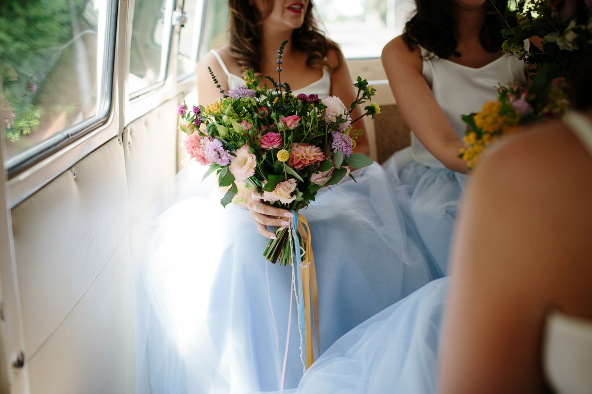 Bride Emma-Jane wore a pale pink skirt and lace top for her Scottish chapel wedding. Her maids wore pale blue and floral crowns. Photography by Caro Weiss.