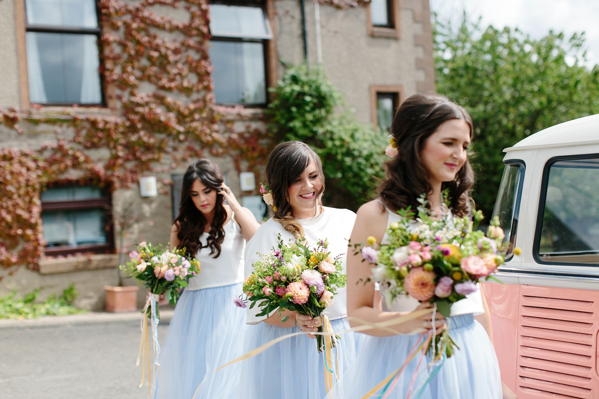 Bride Emma-Jane wore a pale pink skirt and lace top for her Scottish chapel wedding. Her maids wore pale blue and floral crowns. Photography by Caro Weiss.