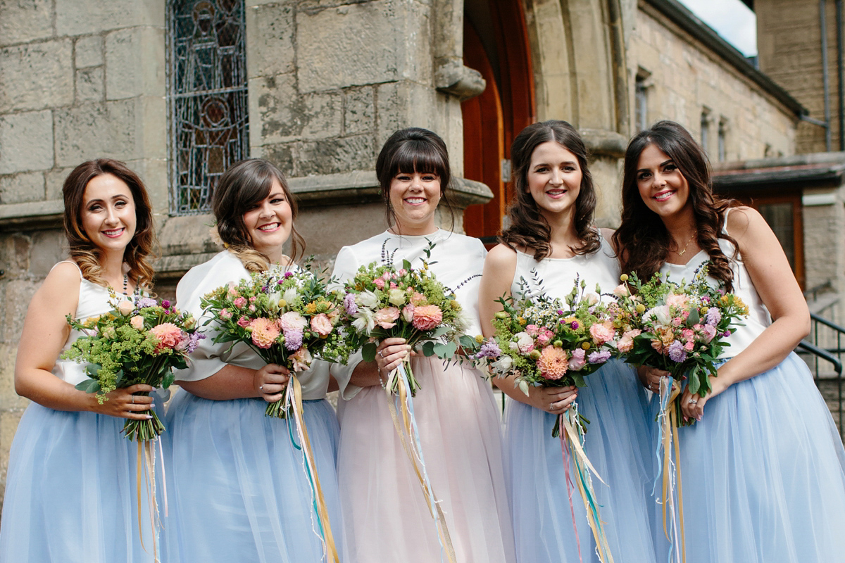 Bride Emma-Jane wore a pale pink skirt and lace top for her Scottish chapel wedding. Her maids wore pale blue and floral crowns. Photography by Caro Weiss.