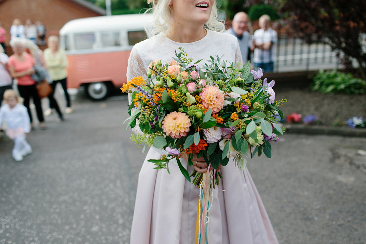 Bride Emma-Jane wore a pale pink skirt and lace top for her Scottish chapel wedding. Her maids wore pale blue and floral crowns. Photography by Caro Weiss.