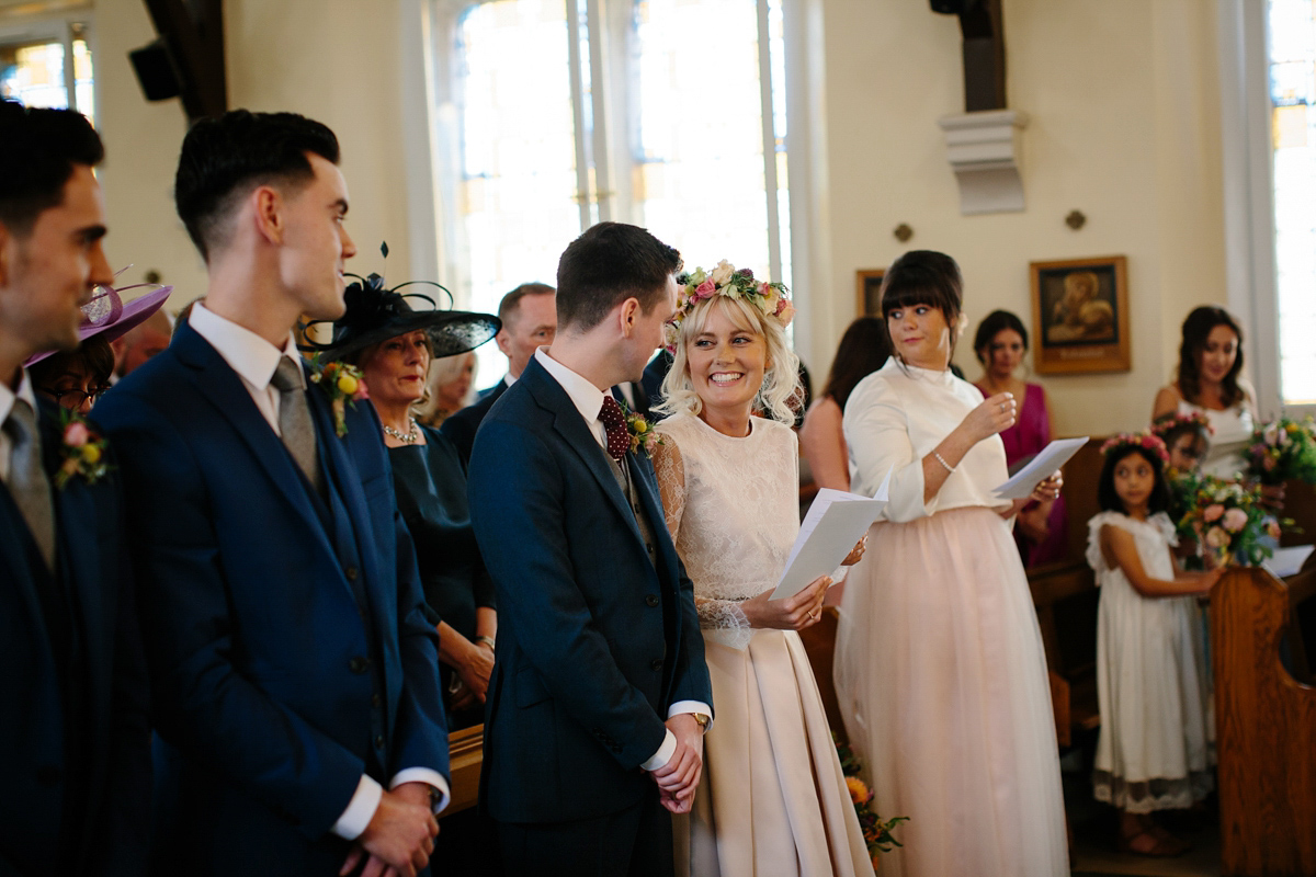 Bride Emma-Jane wore a pale pink skirt and lace top for her Scottish chapel wedding. Her maids wore pale blue and floral crowns. Photography by Caro Weiss.