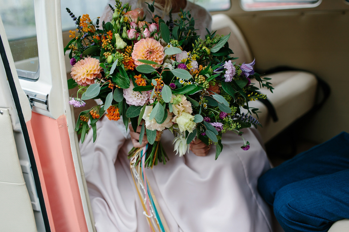 Bride Emma-Jane wore a pale pink skirt and lace top for her Scottish chapel wedding. Her maids wore pale blue and floral crowns. Photography by Caro Weiss.