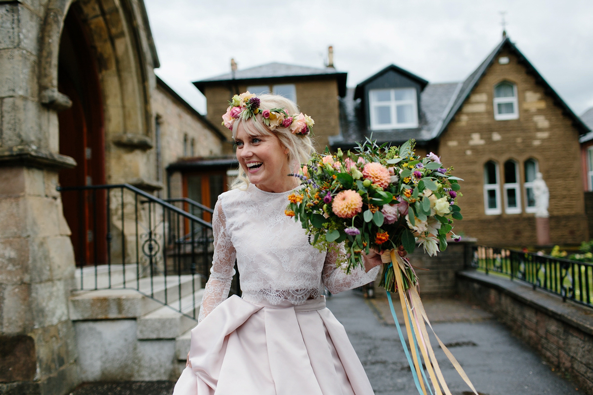 Bride Emma-Jane wore a pale pink skirt and lace top for her Scottish chapel wedding. Her maids wore pale blue and floral crowns. Photography by Caro Weiss.