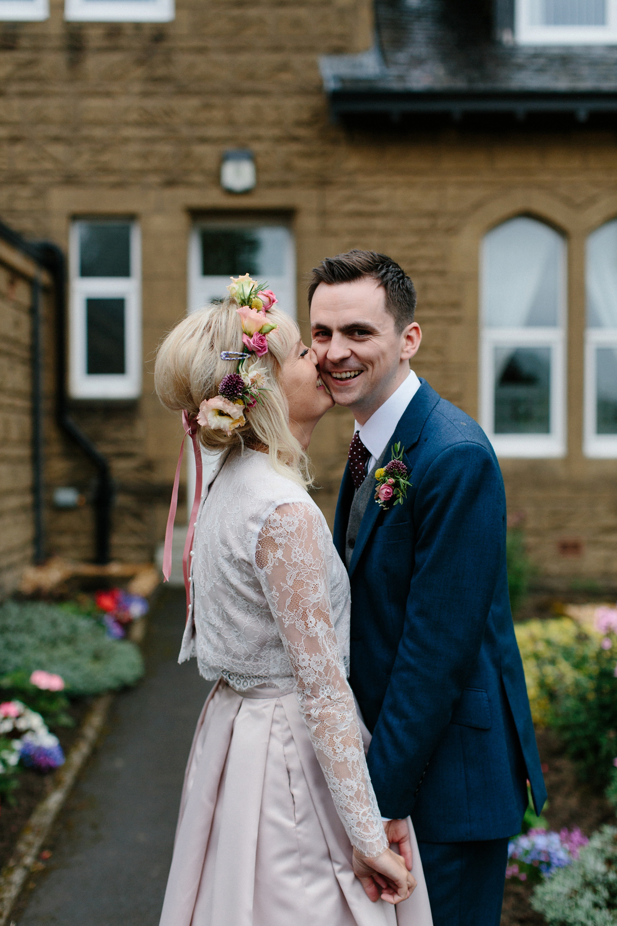 Bride Emma-Jane wore a pale pink skirt and lace top for her Scottish chapel wedding. Her maids wore pale blue and floral crowns. Photography by Caro Weiss.