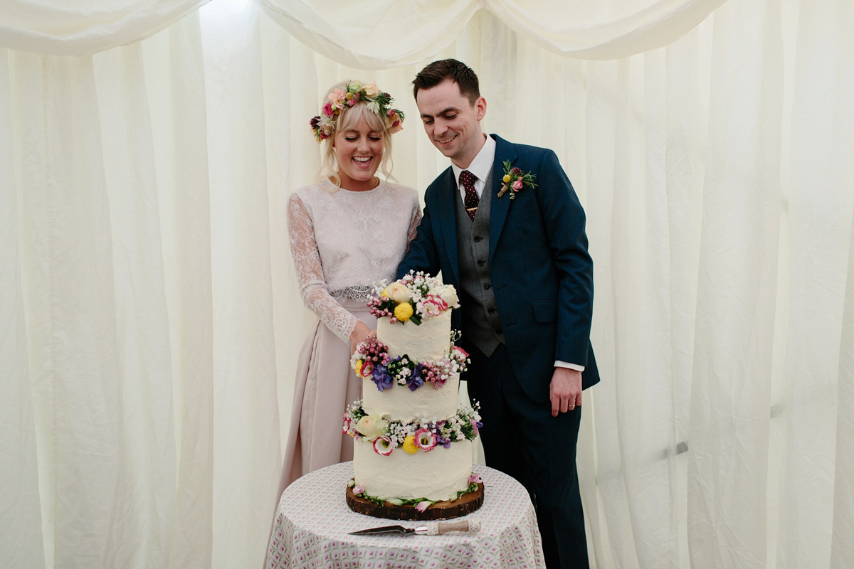 Bride Emma-Jane wore a pale pink skirt and lace top for her Scottish chapel wedding. Her maids wore pale blue and floral crowns. Photography by Caro Weiss.