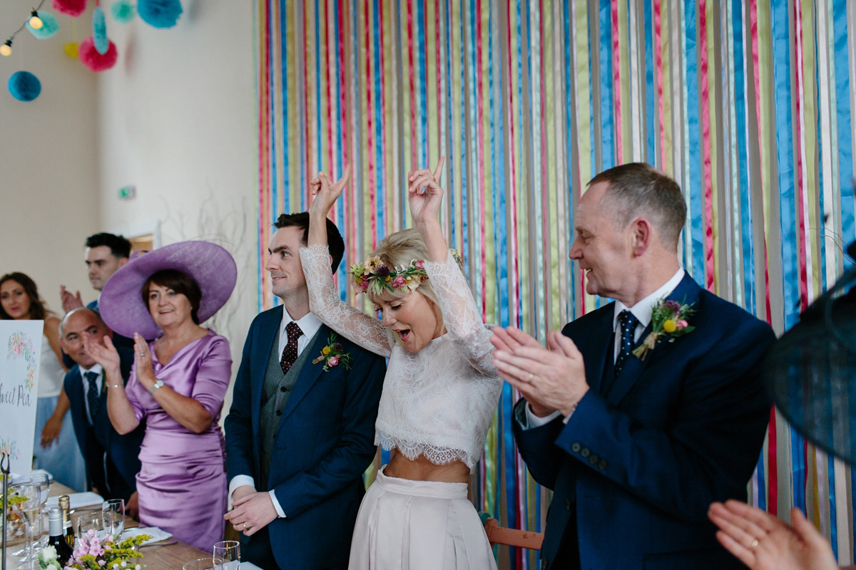 Bride Emma-Jane wore a pale pink skirt and lace top for her Scottish chapel wedding. Her maids wore pale blue and floral crowns. Photography by Caro Weiss.