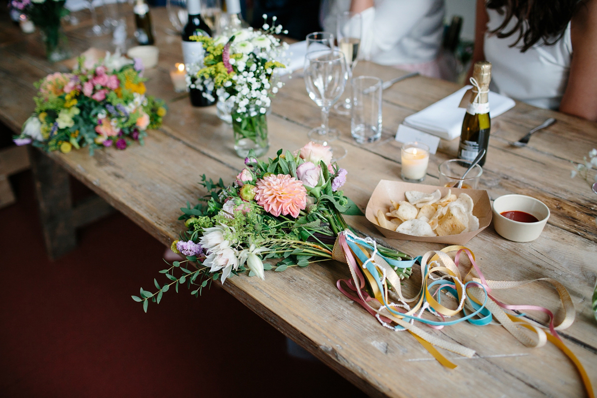 Bride Emma-Jane wore a pale pink skirt and lace top for her Scottish chapel wedding. Her maids wore pale blue and floral crowns. Photography by Caro Weiss.