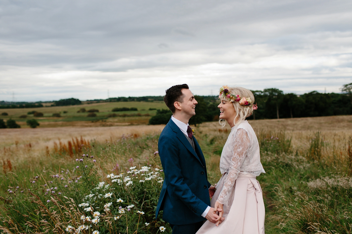 Bride Emma-Jane wore a pale pink skirt and lace top for her Scottish chapel wedding. Her maids wore pale blue and floral crowns. Photography by Caro Weiss.