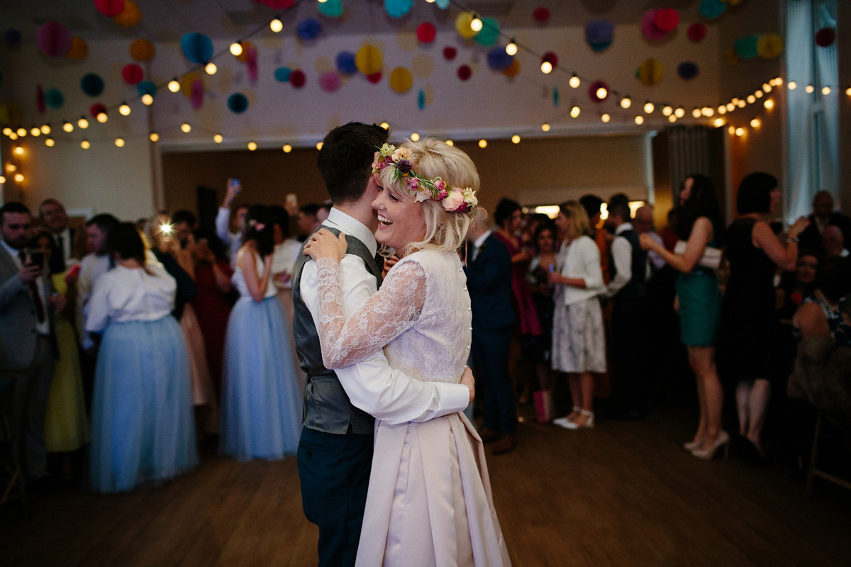 Bride Emma-Jane wore a pale pink skirt and lace top for her Scottish chapel wedding. Her maids wore pale blue and floral crowns. Photography by Caro Weiss.