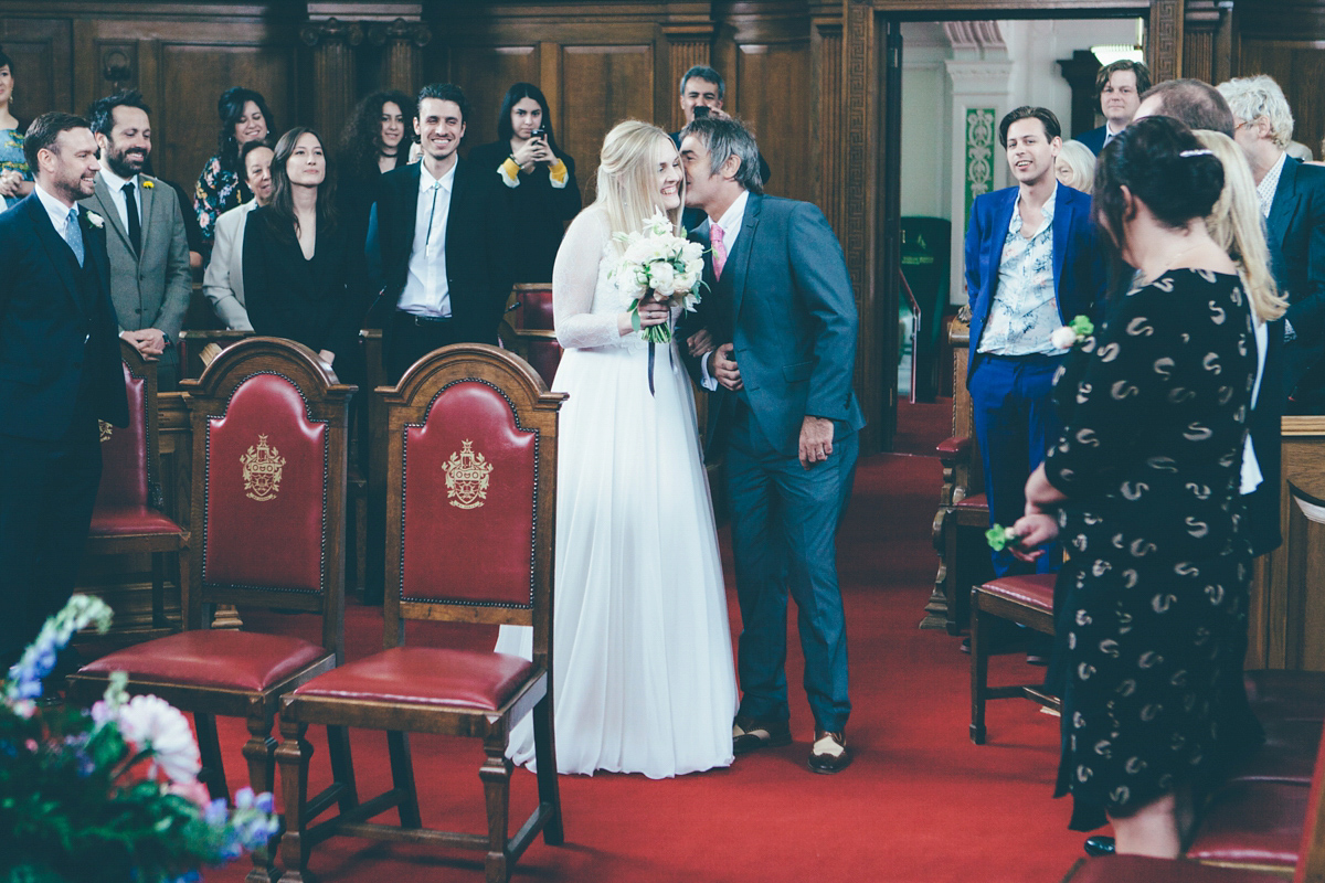 Ash wore a Jesus Peiro gown and winged shoes by Sophia Webster for her stripped back and fuss free wedding in London. Captured by September Pictures.