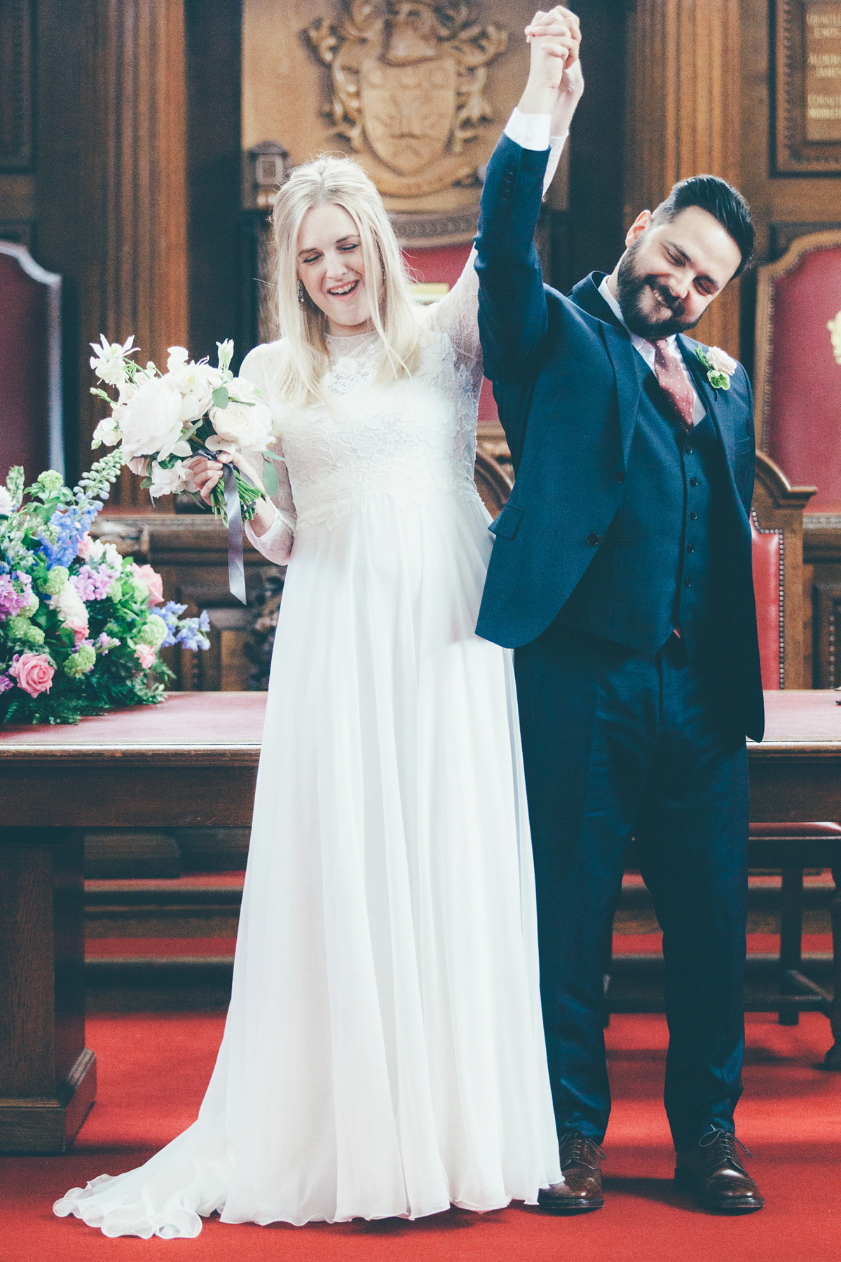 Ash wore a Jesus Peiro gown and winged shoes by Sophia Webster for her stripped back and fuss free wedding in London. Captured by September Pictures.