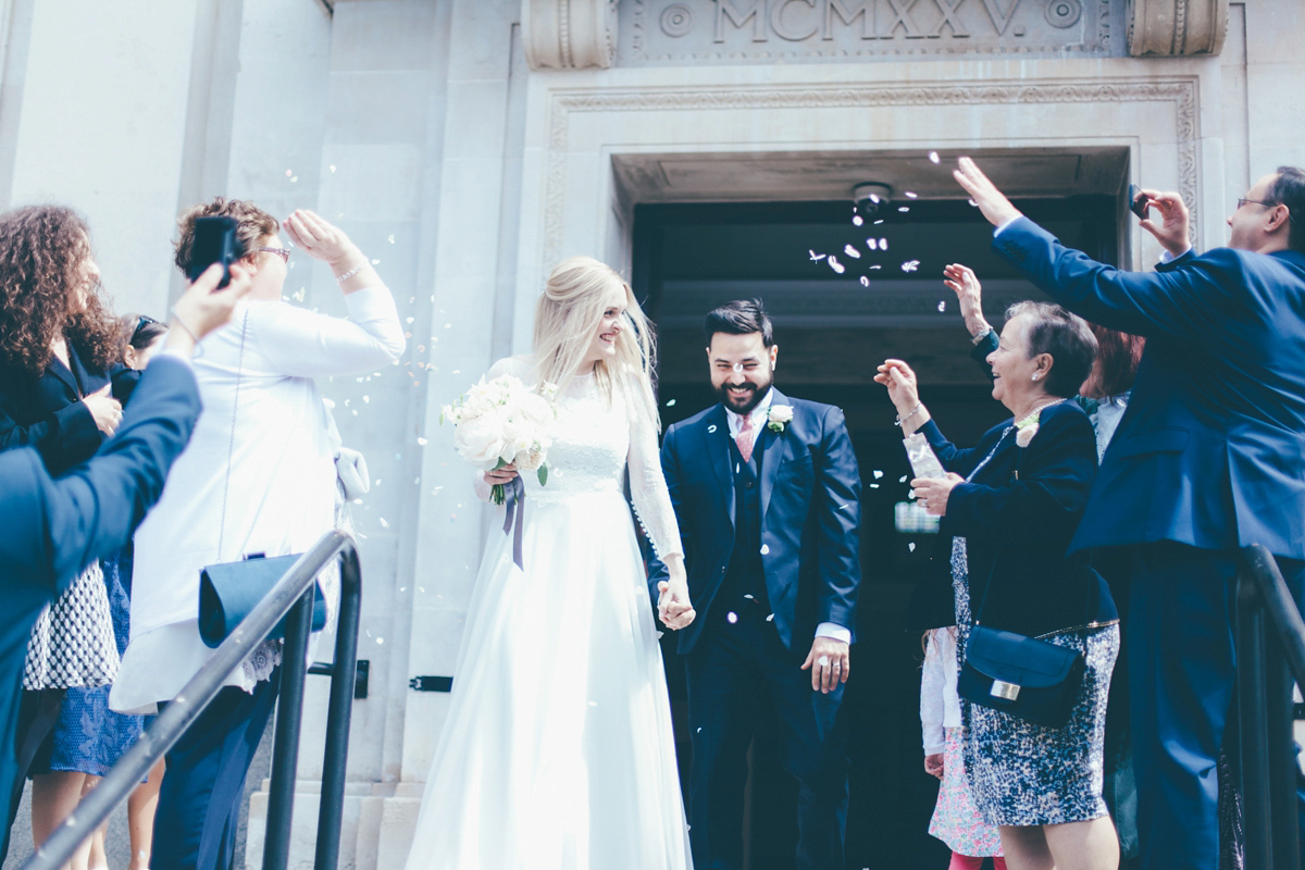 Ash wore a Jesus Peiro gown and winged shoes by Sophia Webster for her stripped back and fuss free wedding in London. Captured by September Pictures.